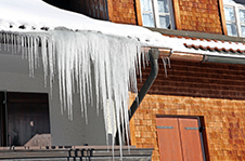 Ice dam along a roof edge in winter